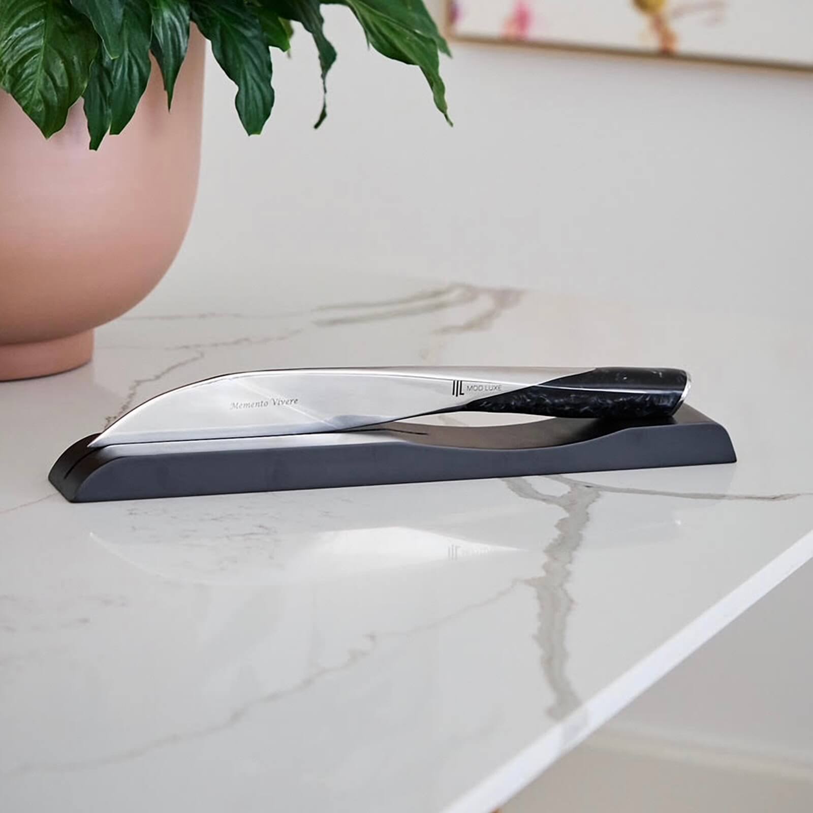 Personalised engraved stainless steel champagne sabre by MOD LUXE – SPLENDOUR elegantly displayed on a wooden stand atop a marble surface, symbolising craftsmanship, luxury, and the perfect gift for champagne lovers and celebrations.