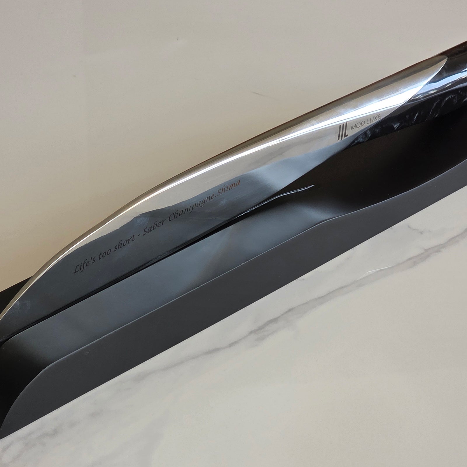 The SPLENDOUR Champagne Sabre by MOD LUXE – a personalised engraved champagne sabre elegantly displayed on its stand, highlighting superior craftsmanship, refined luxury presentation, and timeless appeal as an unforgettable personalised gift for champagne lovers and any occasion.